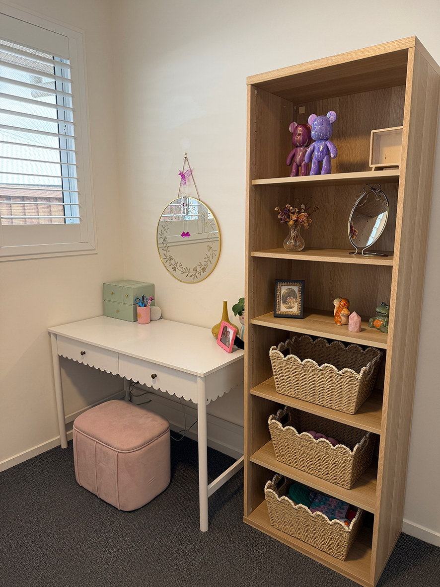 Wardrobe shelves organised with woven baskets and handbags
